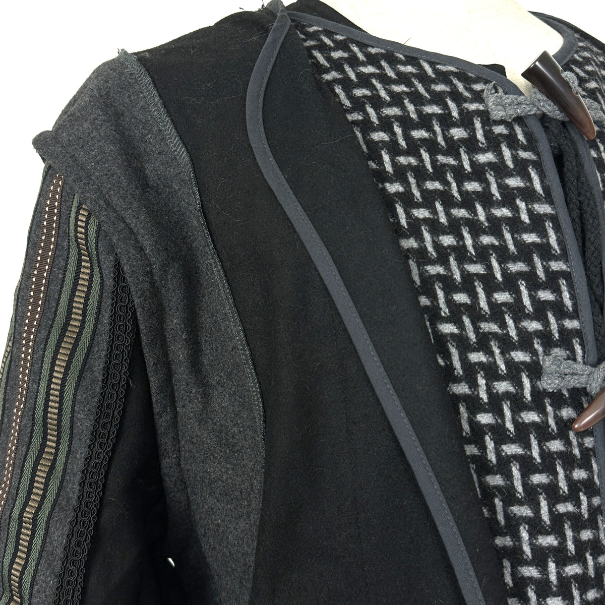 Detail of wool fabric texture and ornate braiding on medieval fantasy cosplay jacket.