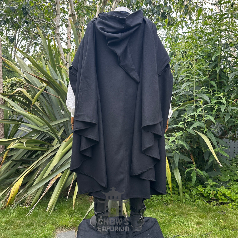 Medieval LARP costume back view featuring black cloak, waistcoat, shirt, pants, sash and necklace. For Renaissance Faire and historical roleplay events.