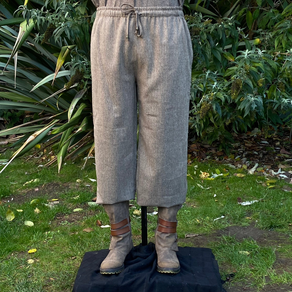 Brown LARP trousers, front view, with drawstring waist and leather boots.