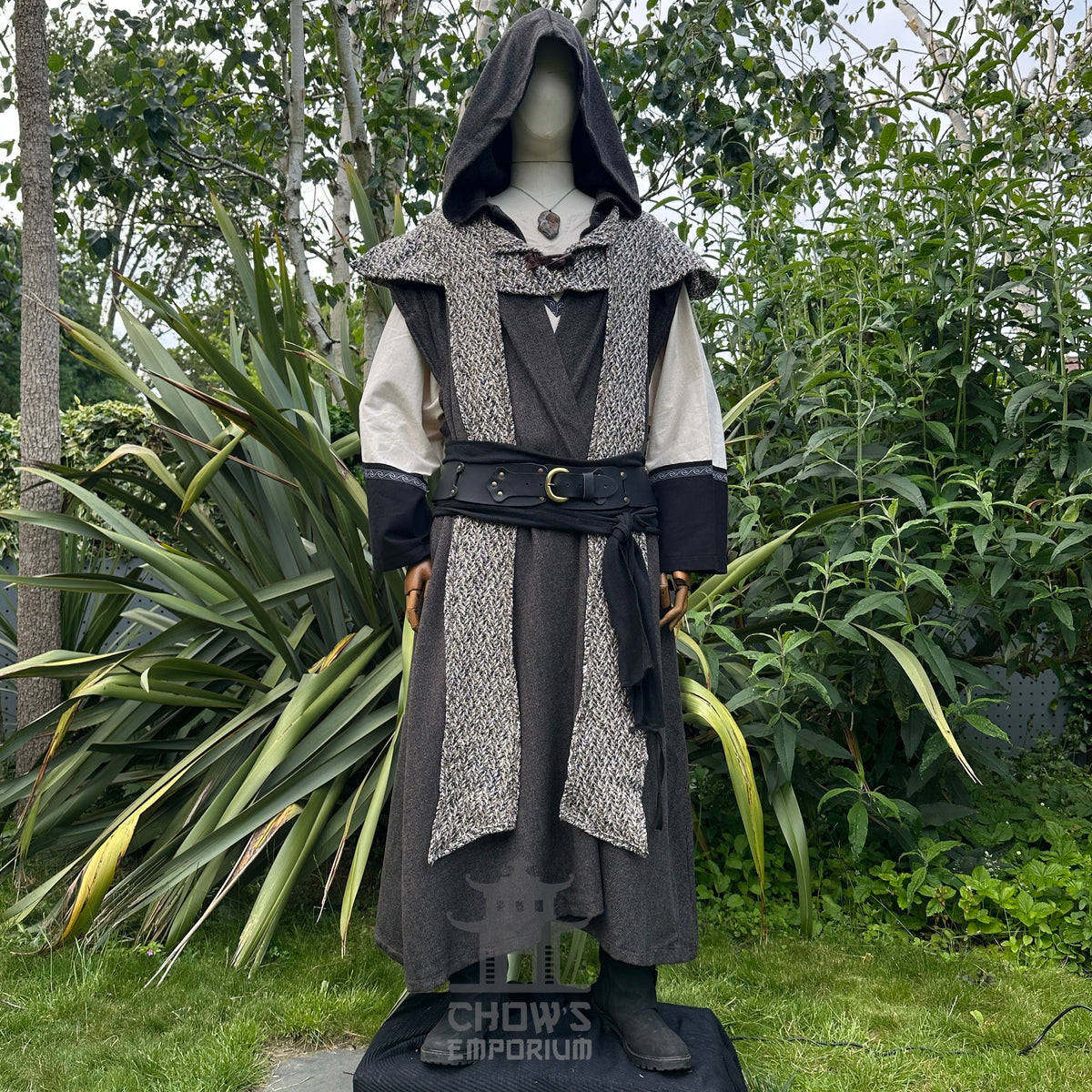 Dark hooded medieval LARP robe, tunic, and belt set against greenery.