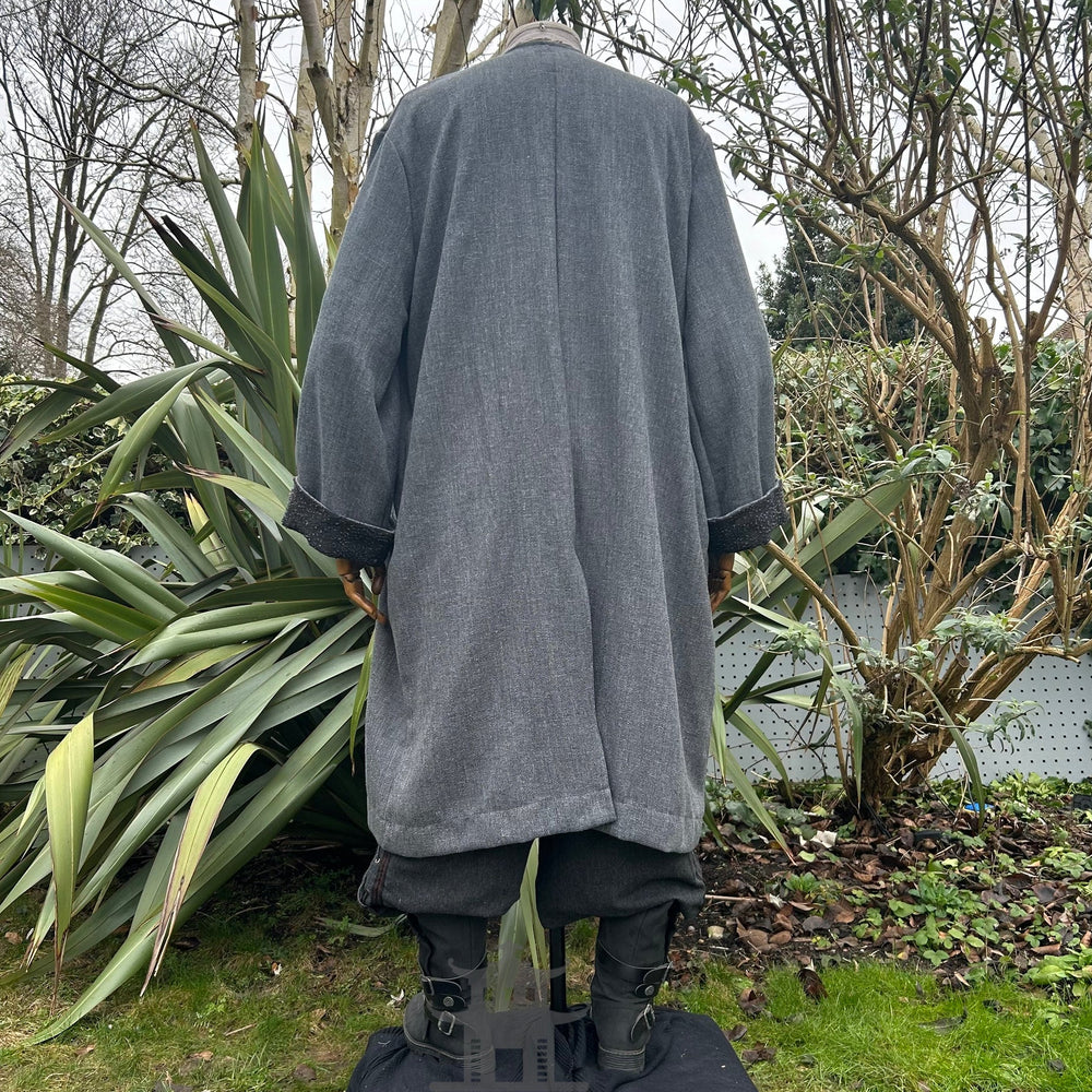 Medieval LARP outfit back view, featuring a grey two-tone jacket, shirt, trousers, belt and sash. For Renaissance Faire and historical roleplay events.