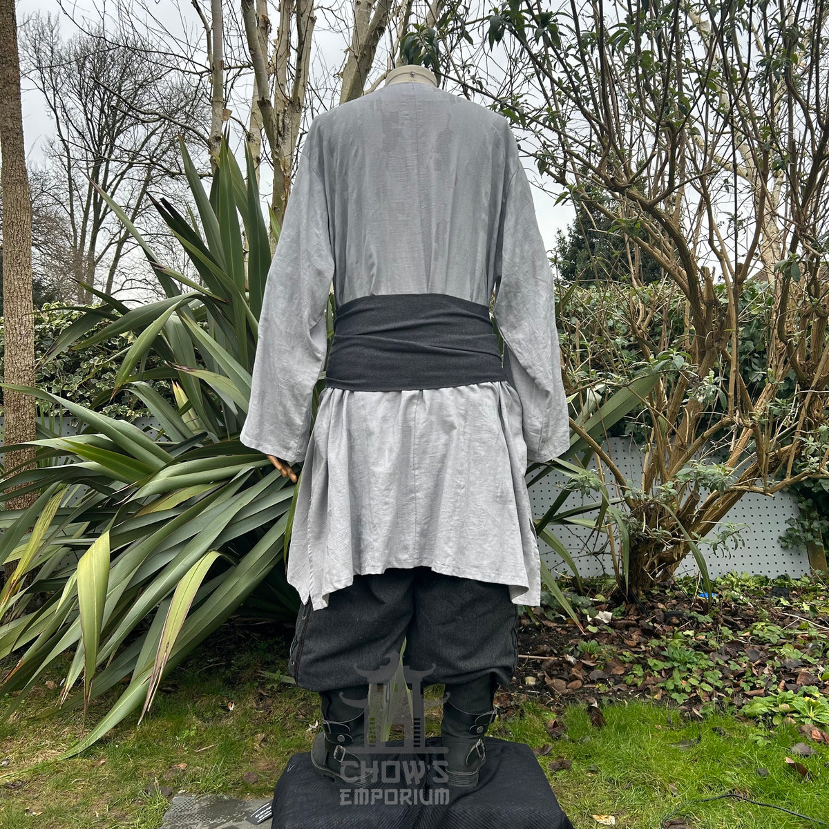 Grey long-sleeved LARP robe with black sash, black pants, rear view.