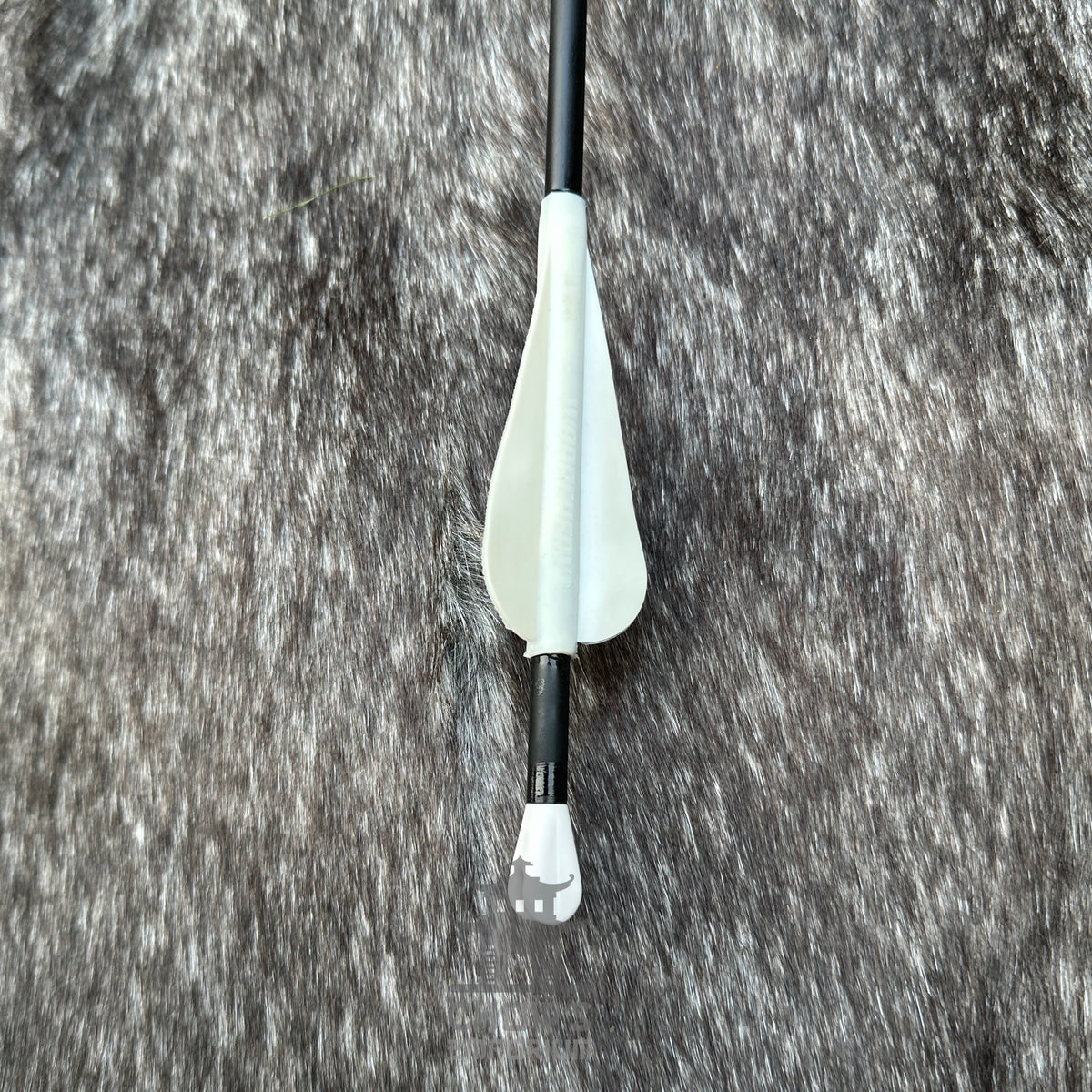 Bow arrow with white nock on a textured grey background.
