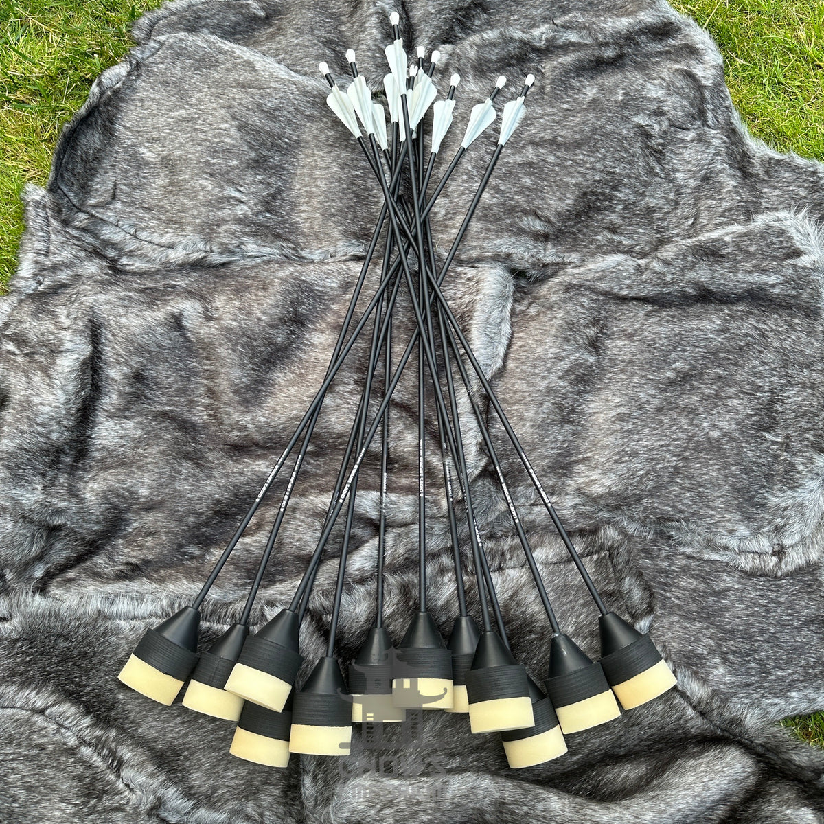Selection of black arrows on faux fur surface for LARP.