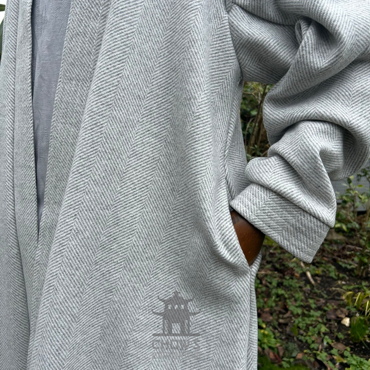 Pocket detail on light grey herringbone medieval LARP robe, authentic fantasy cosplay costume.