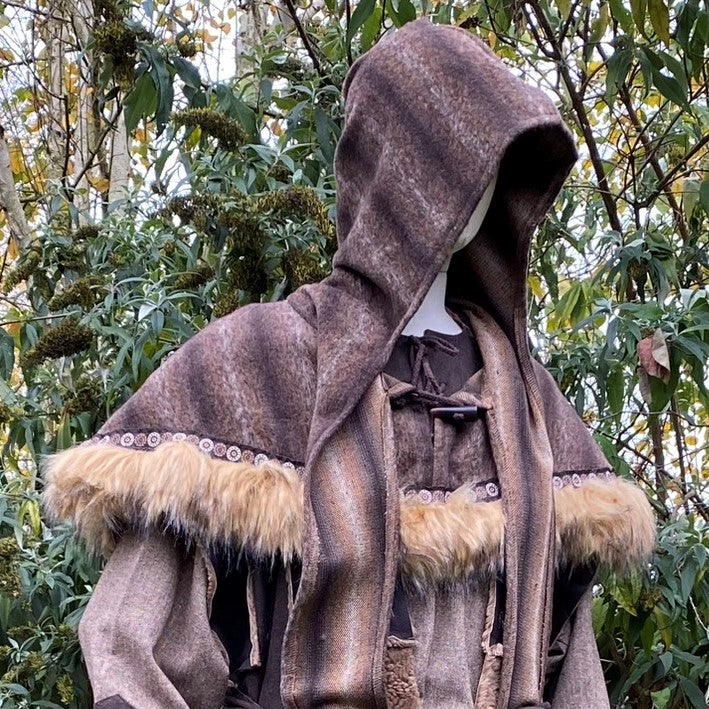 Medieval LARP alchemist set close-up; hooded cloak with fur trim.