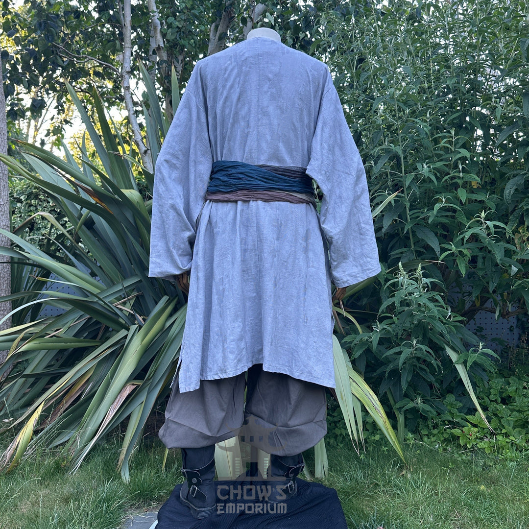 Medieval LARP outfit back view, featuring a grey cotton tunic, trousers and sash. For Renaissance Faire and historical roleplay events.