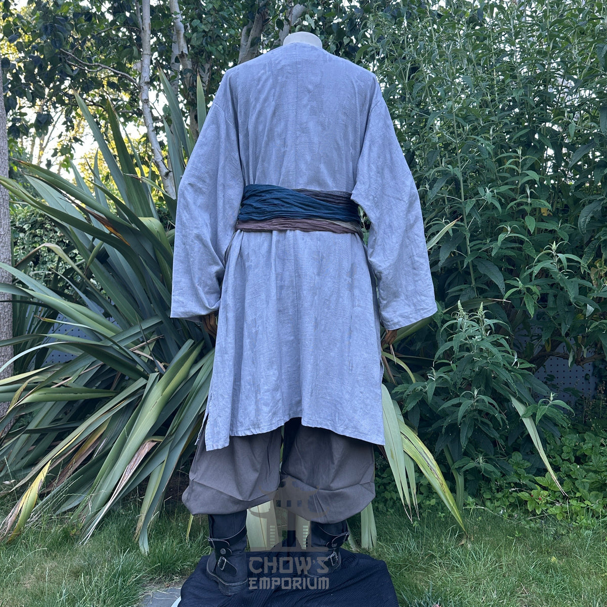 LARP costume set with grey robe, trousers, blue sash, back view.