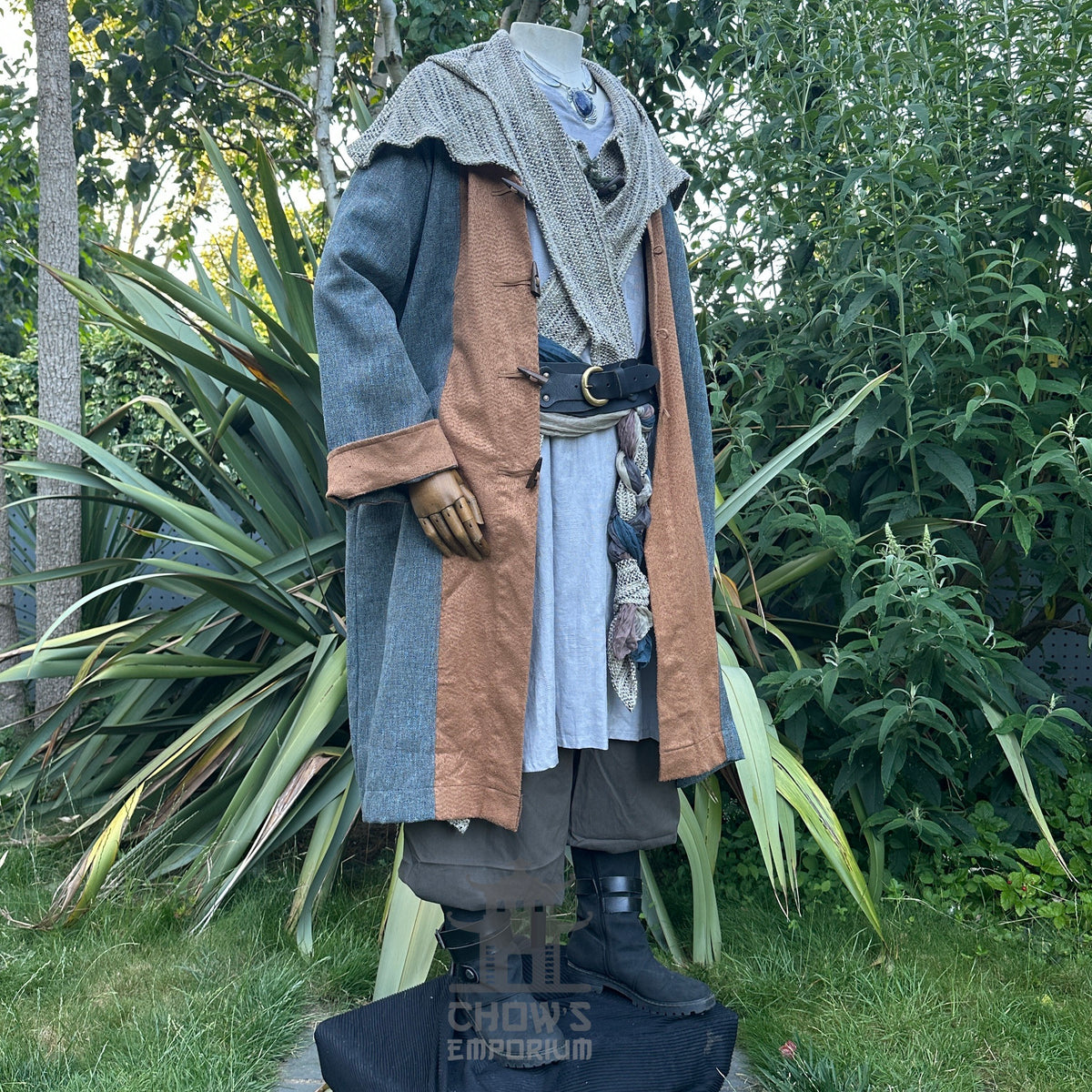 Medieval LARP costume with teal-brown coat, layered scarf on mannequin.