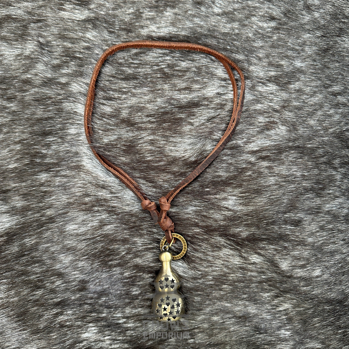 Medieval LARP lucky gourd necklace with brown leather cord on fur backdrop.