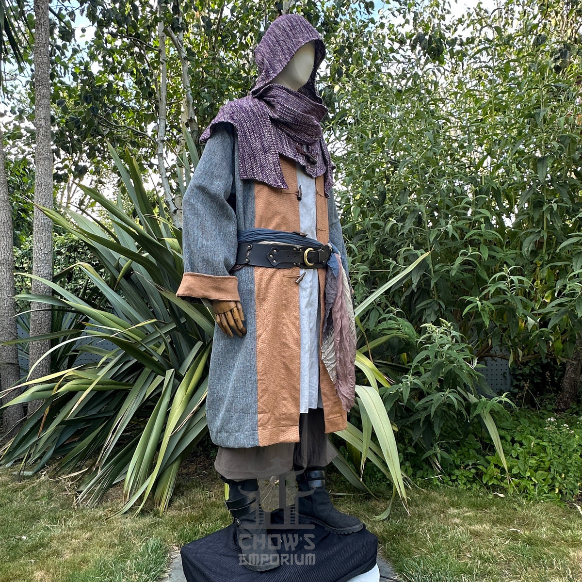 Medieval LARP costume side view, featuring a pirate coat in teal and brown, cotton tunic, wool.