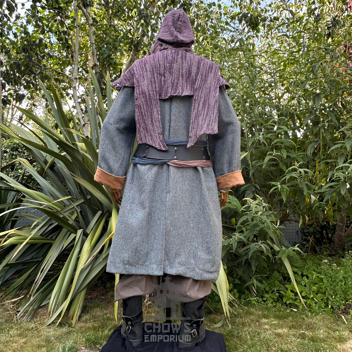 Medieval LARP costume back view, featuring a pirate coat in teal and brown, cotton tunic, wool.