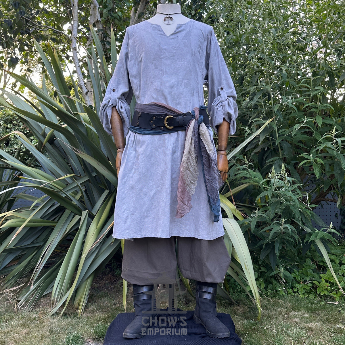 Grey LARP tunic, trousers, and sash on display, fabric folds visible.