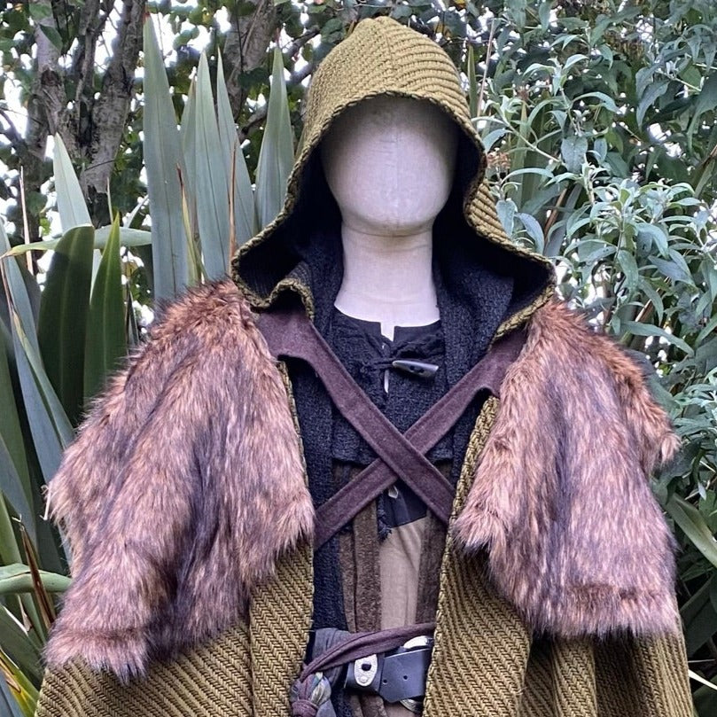 Medieval LARP outfit with faux fur mantle and hood, forest backdrop.