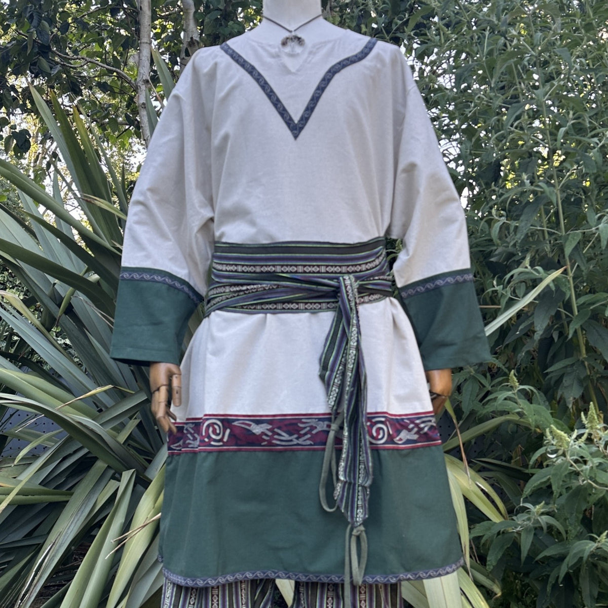 Medieval LARP outfit with green trim and sash, front view.