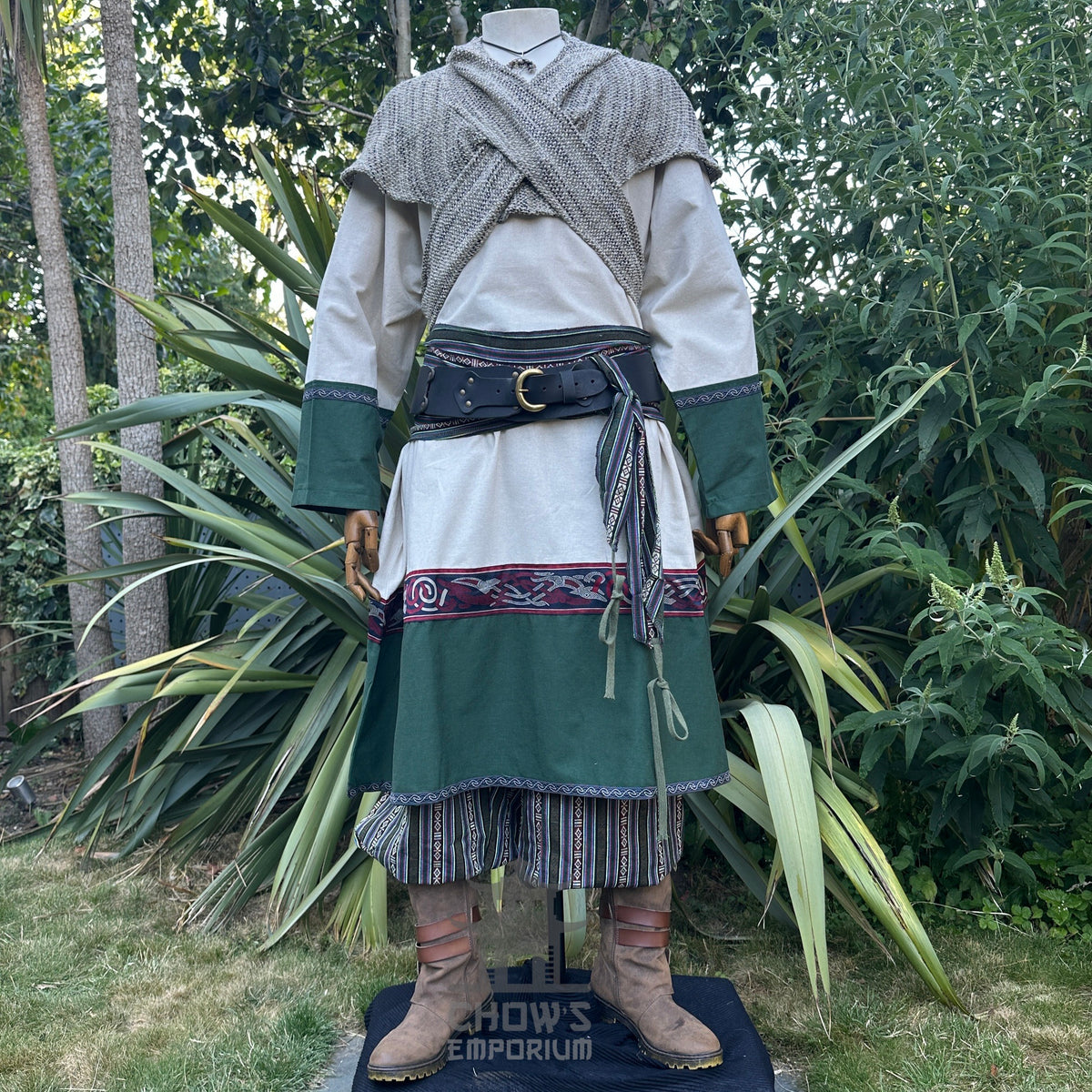 LARP outfit with patterned tunic trim, wool hood, and striped trousers.