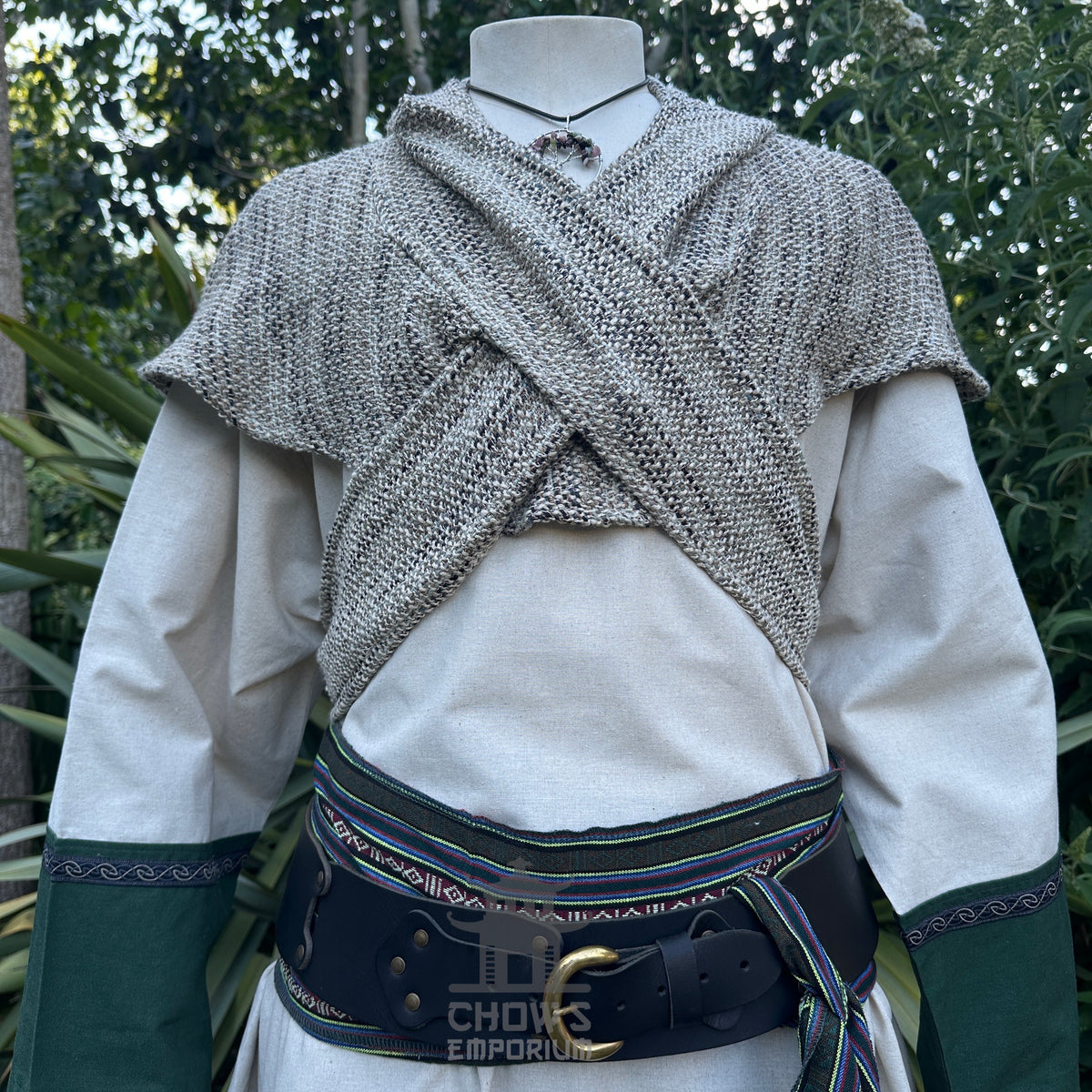 Medieval LARP outfit close-up with knitted shoulder cape and detailed belt.