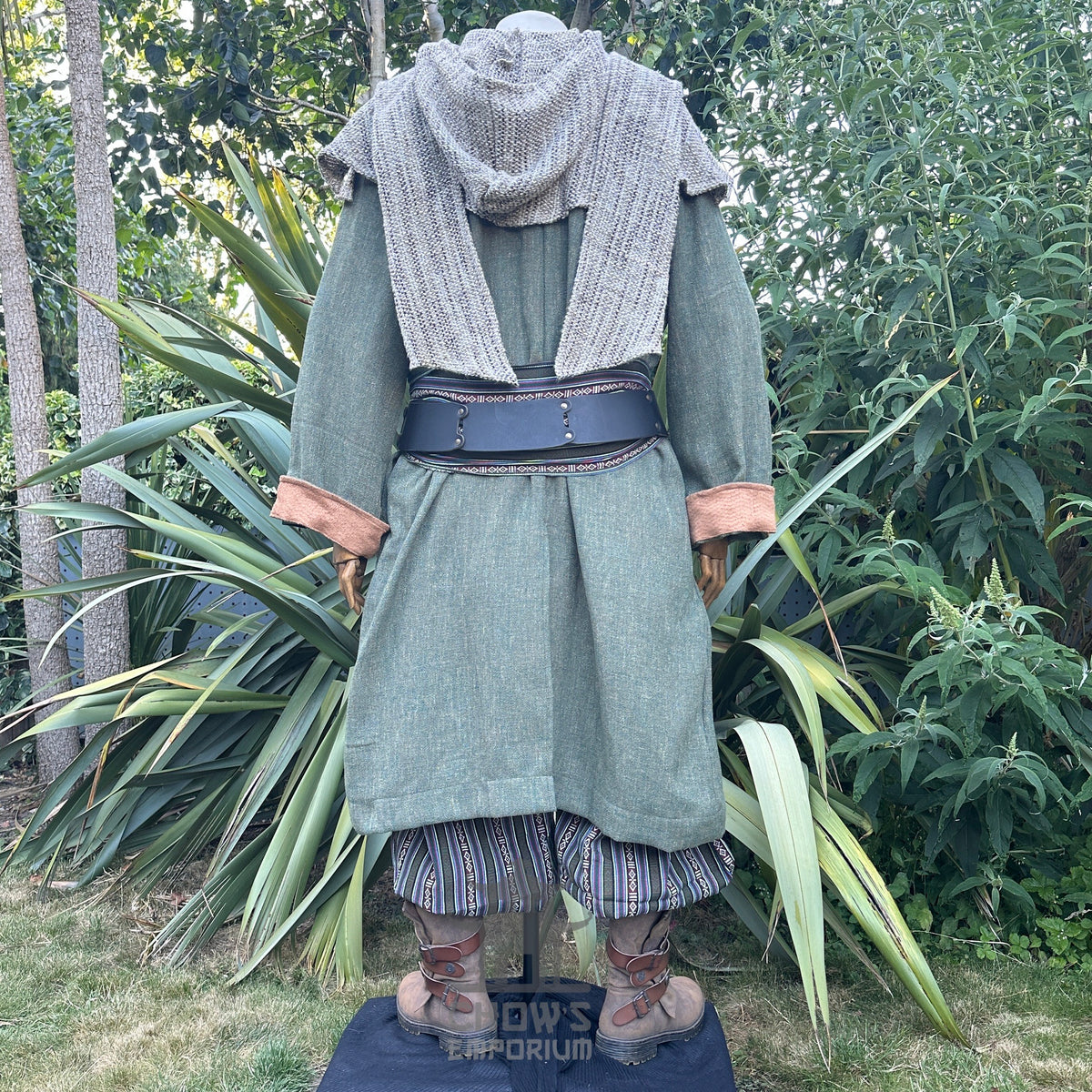 Green medieval LARP outfit rear view, knit hood, jacket, and striped pants.