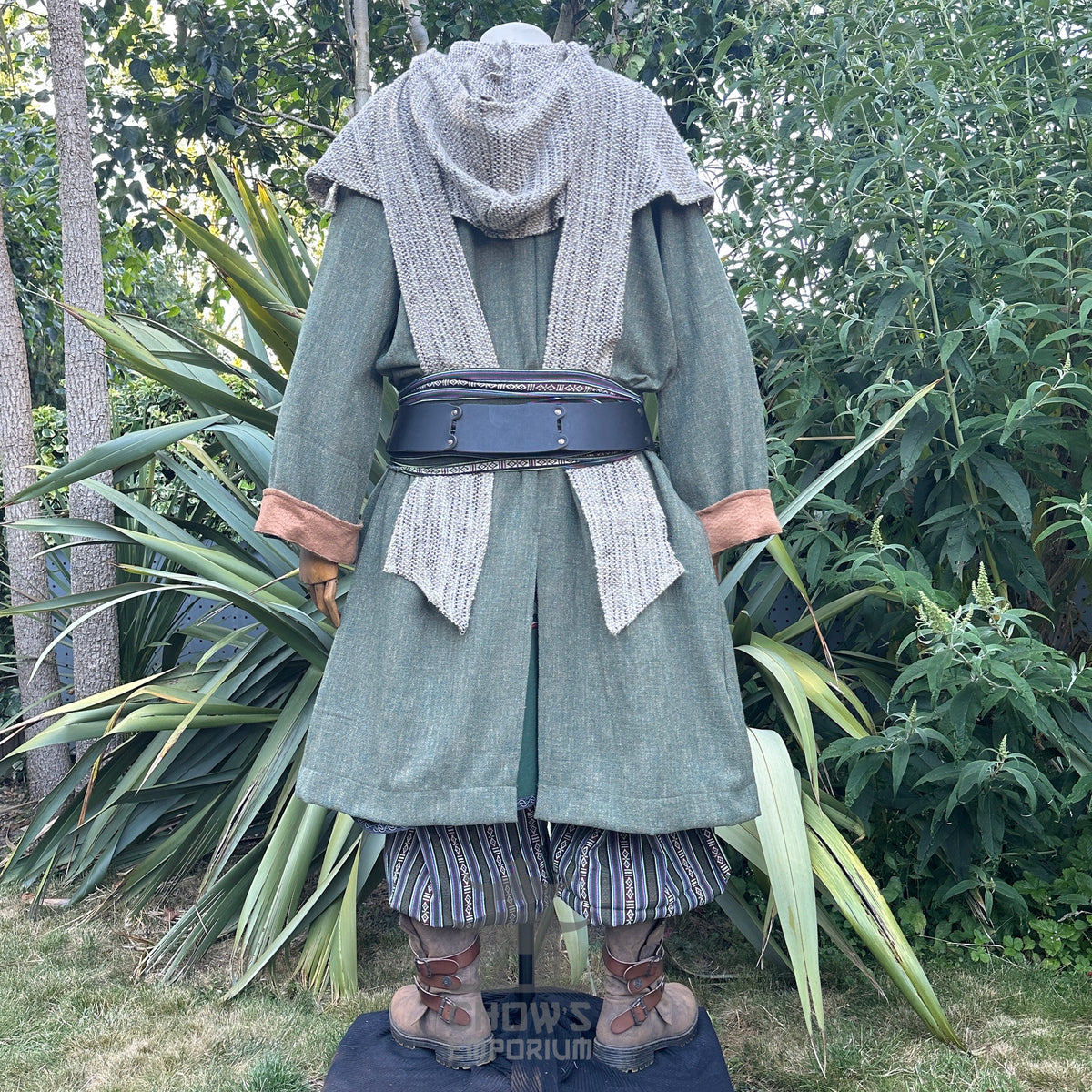 Medieval LARP costume back view featuring a green pirate coat, tunic, hood, sash and necklace.