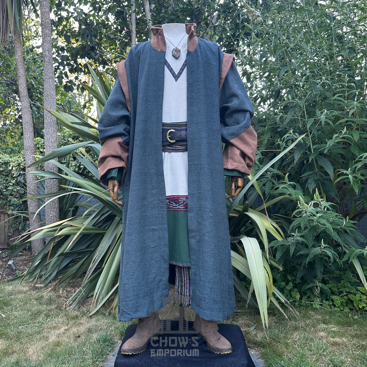 Viking Healer LARP outfit front view: blue robe, brown cuffs, necklace.