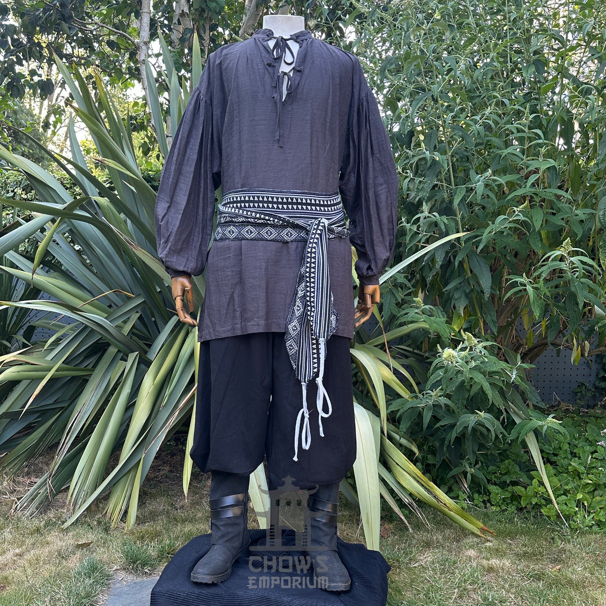 LARP necromancer outfit with black shirt, sash, and trousers.