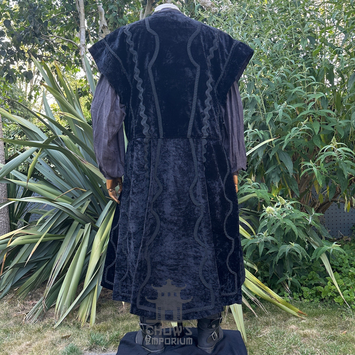 Back view of black velvet medieval LARP waistcoat with grey shirt and sash.