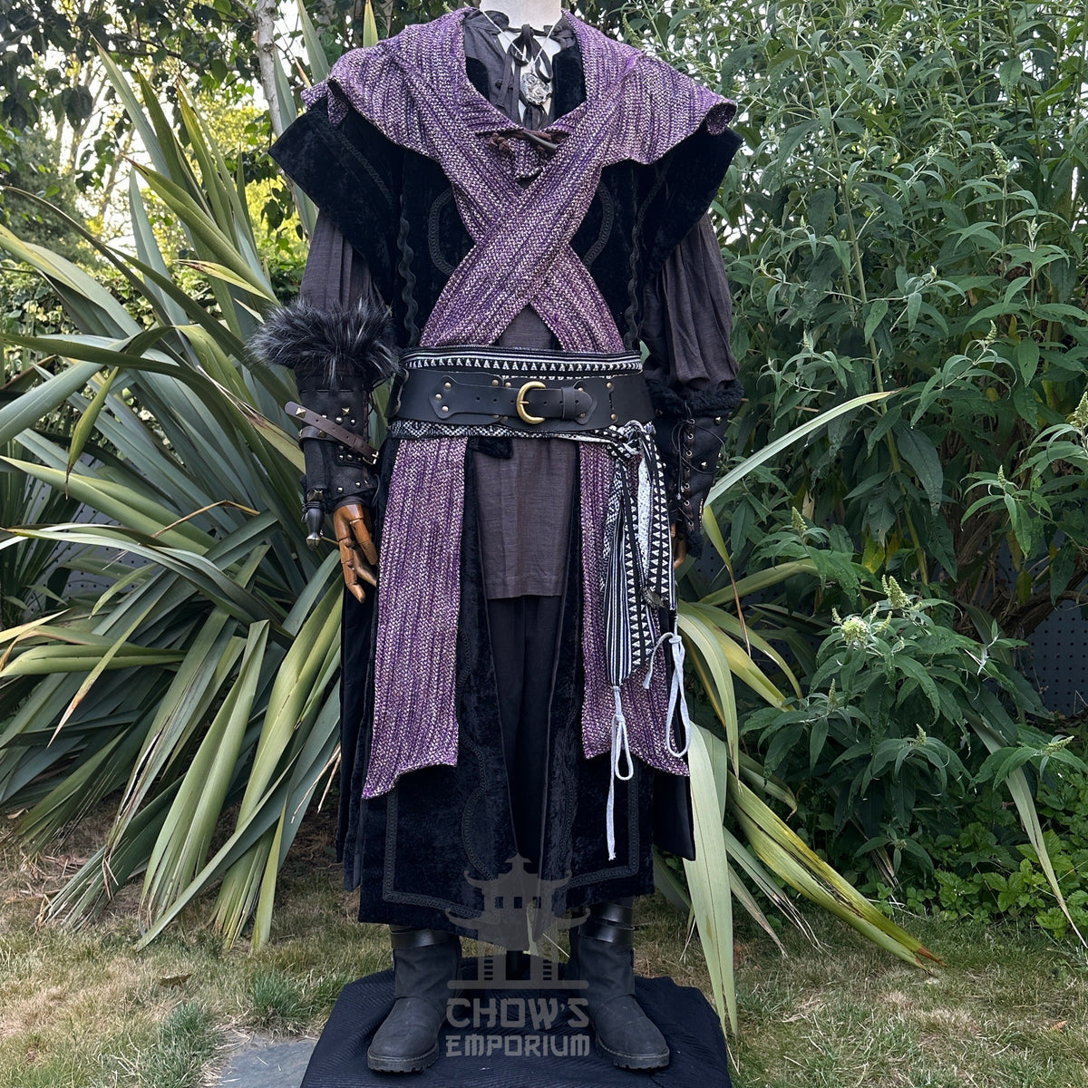 LARP medieval costume, black waistcoat, purple hood, and sash, front view.