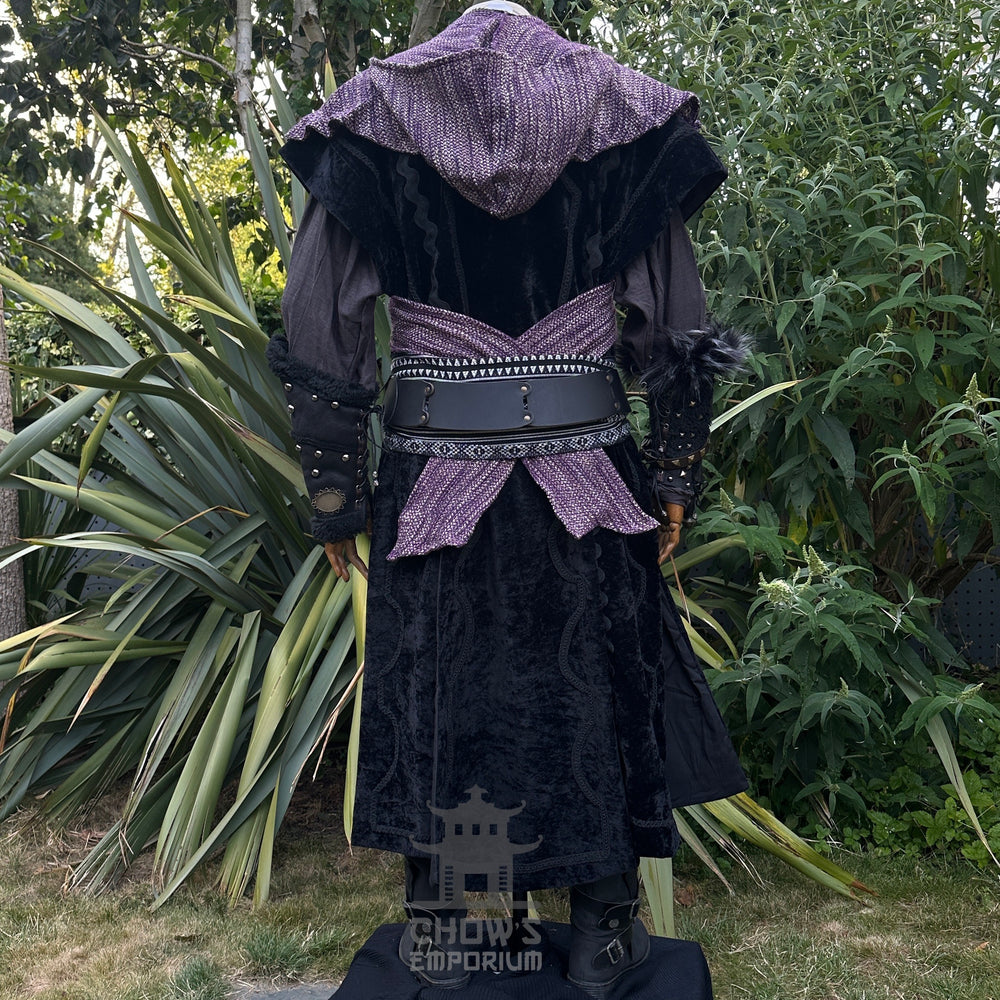 Medieval LARP outfit back view, featuring black suede-effect waistcoat, purple hood and sash. For Renaissance Faire and historical roleplay events.