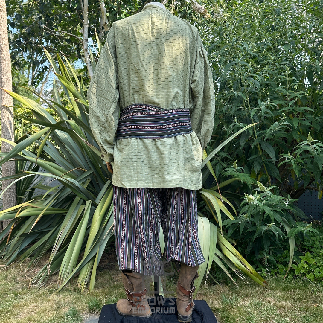 Medieval LARP outfit back view, featuring a green shirt, patterned trousers, matching sash. For Renaissance Faire and historical roleplay events.