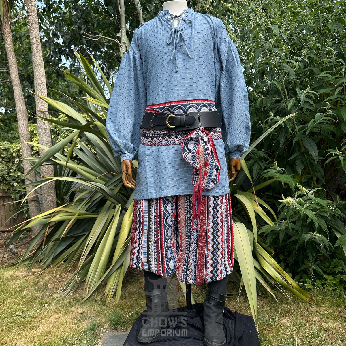 Medieval LARP shirt in blue cotton linen, side garden display with belt.