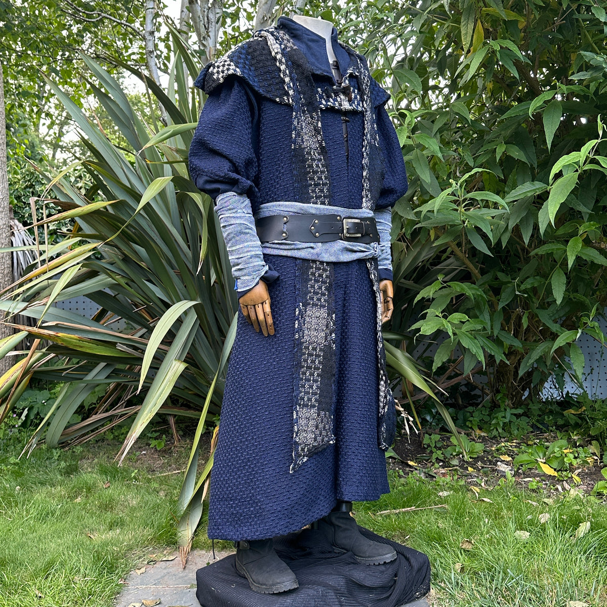Medieval LARP attire with textured robe, hood, and detailed belt.