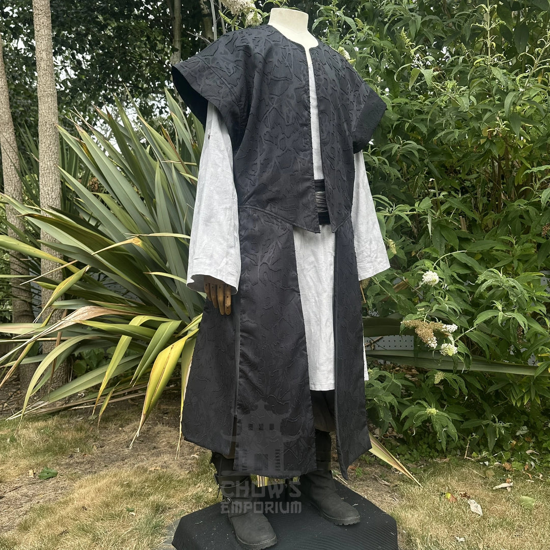 Black panelled waistcoat and hood set worn open at the front over a shirt, full-length front view. Shirt and belt sold separately.