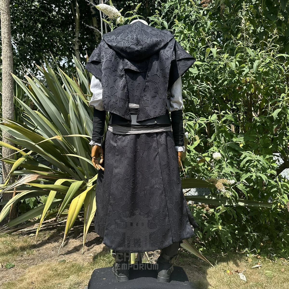 Black panelled waistcoat and hood set, hood up, back three-quarter view showing the pointed hood. Belt sold separately.