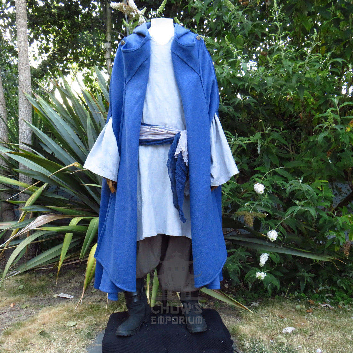 Blue cloak worn open down the front over a tunic and sash, other pieces sold separately