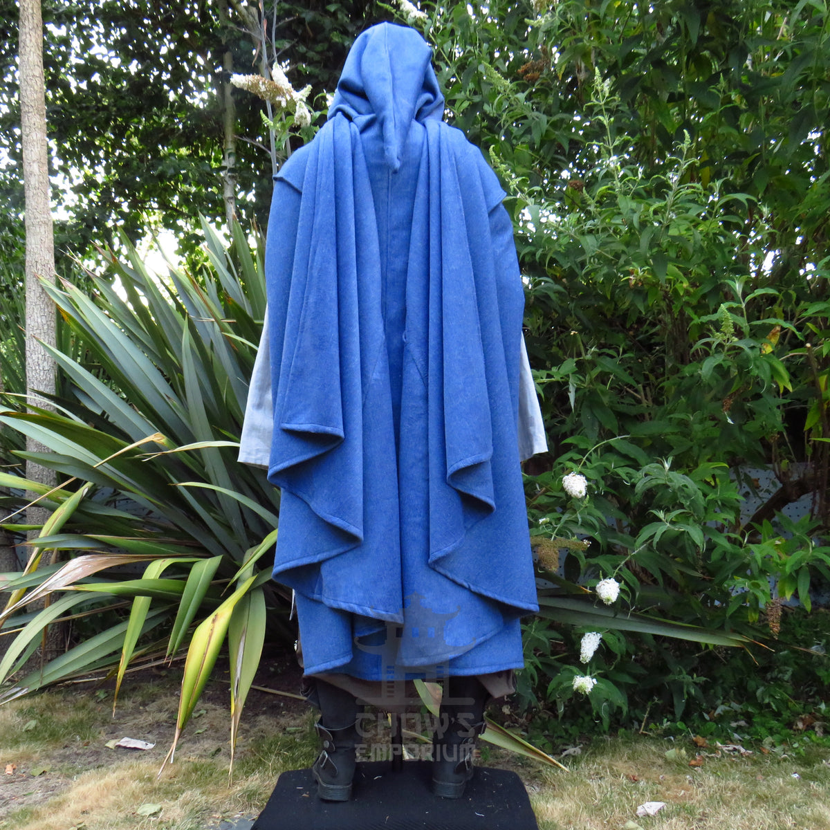 Back view of the blue hooded cloak showing the full sweep of the hem