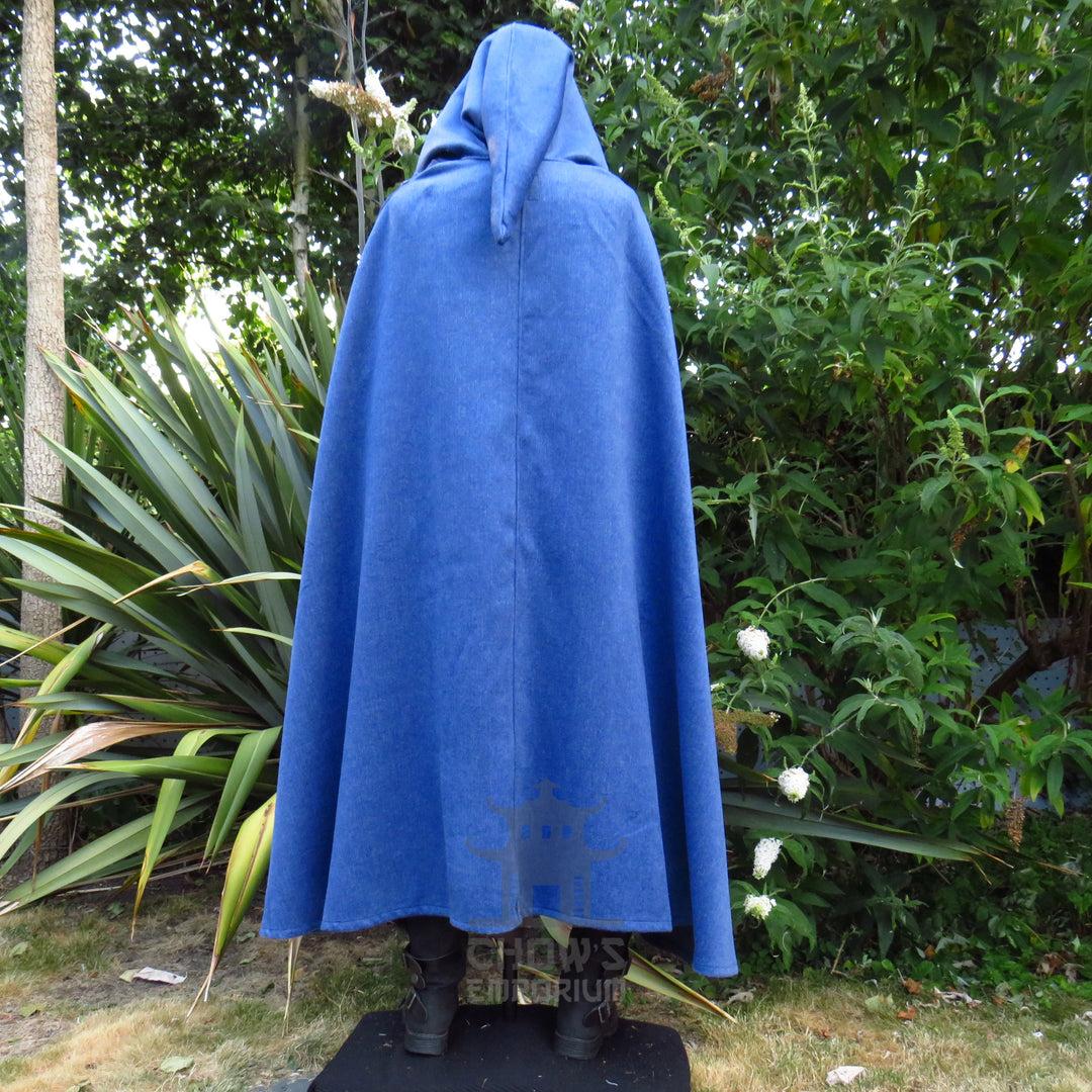Blue wool hooded cloak worn closed with the deep hood pulled up, front view