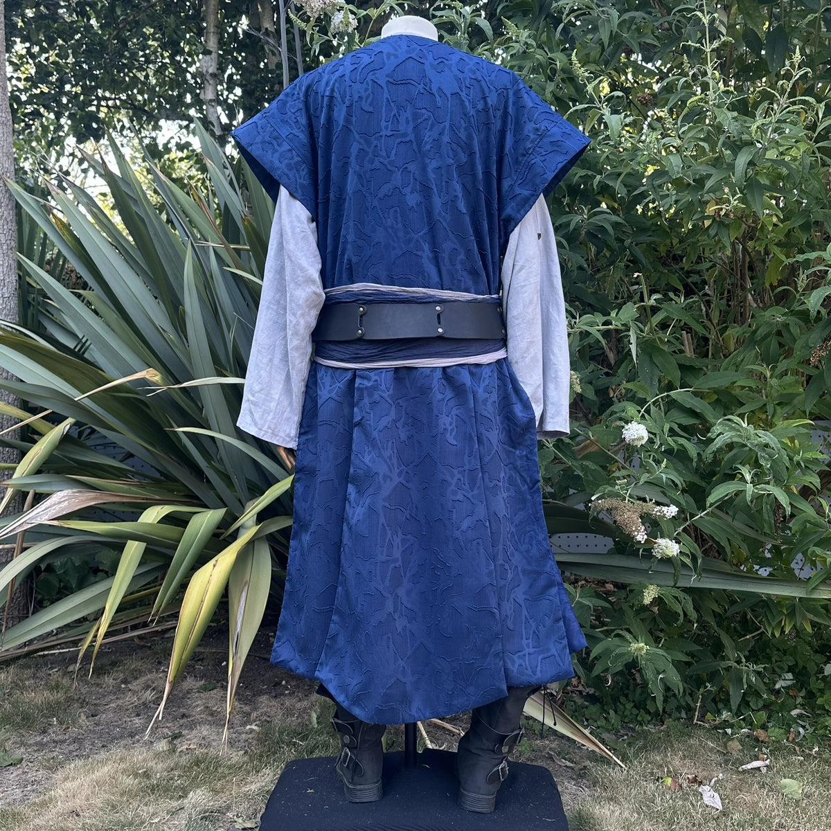 Blue panelled waistcoat and hood set, hood down, back view showing the panelled back. Belt sold separately.