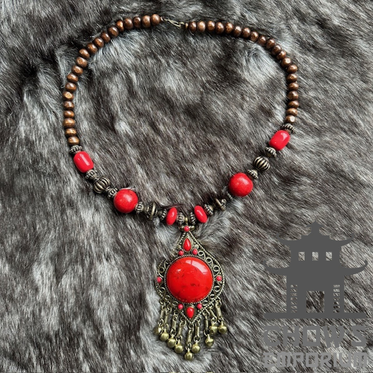 Red beaded necklace with wooden beads and a central red stone