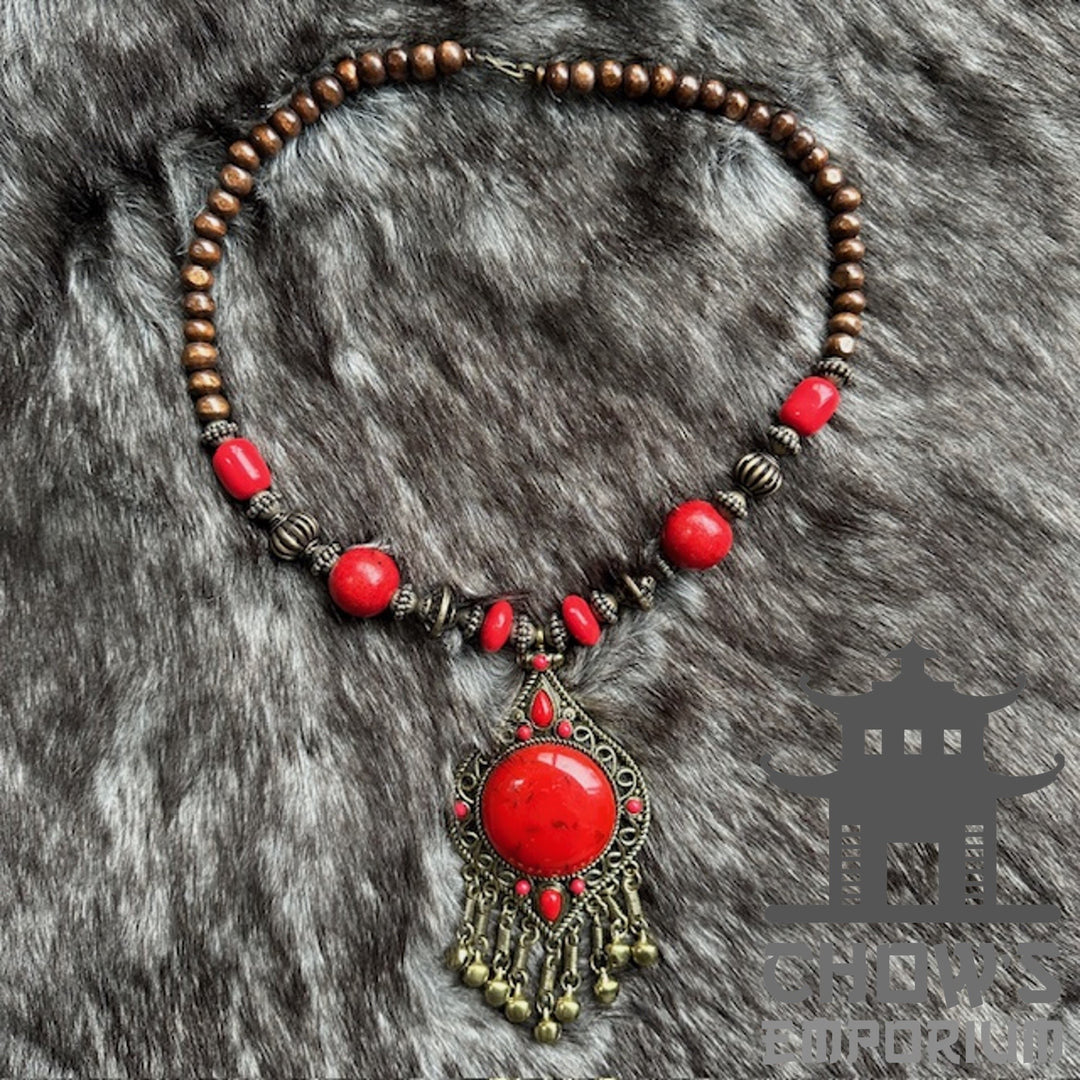 Red beaded necklace with wooden beads and a central red stone