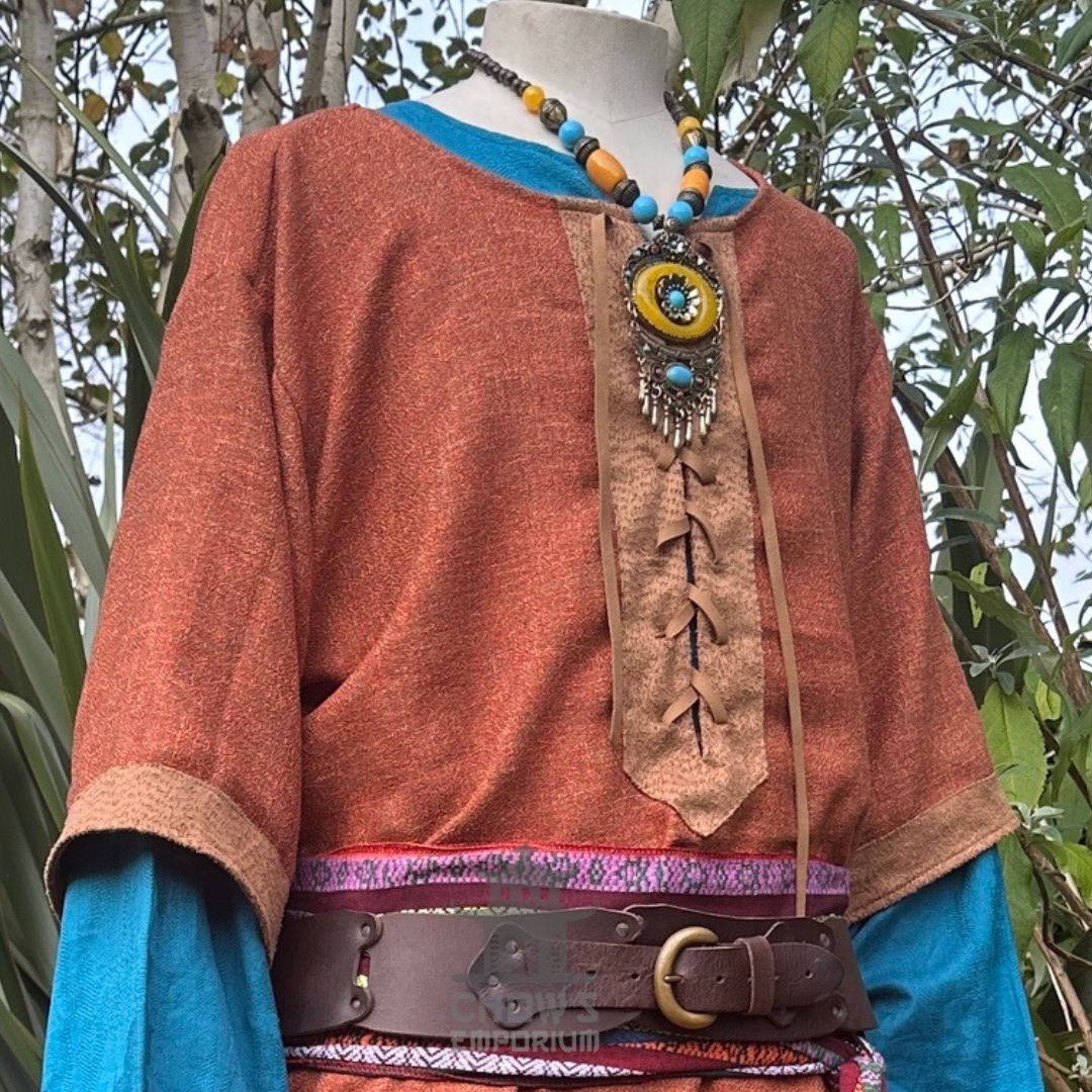 Orange and brown woven medieval tunic for LARP, close-up with necklace.