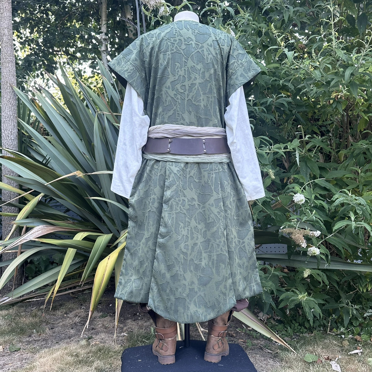 Green panelled waistcoat and hood set, hood down, back view showing the panelled back. Belt sold separately.