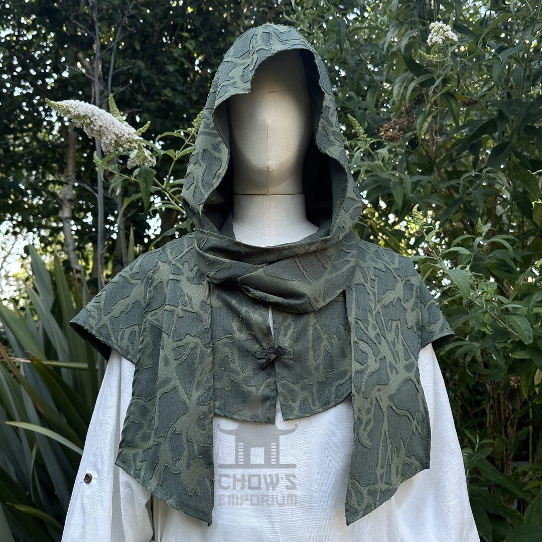 Green medieval scarf hood worn up over the head, wraparound ends draped