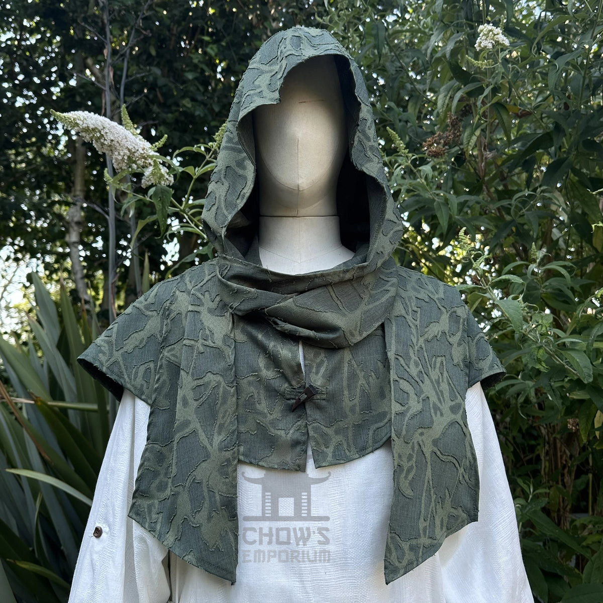 Green medieval scarf hood worn up over the head, wraparound ends draped