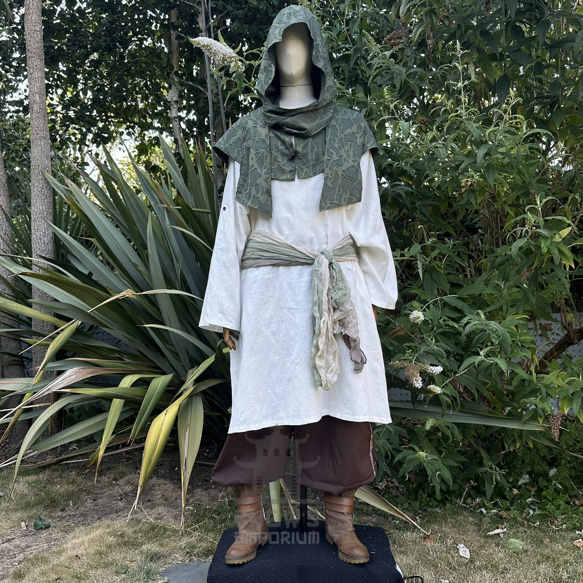 Green scarf hood worn as a cowl round the shoulders over a white shirt