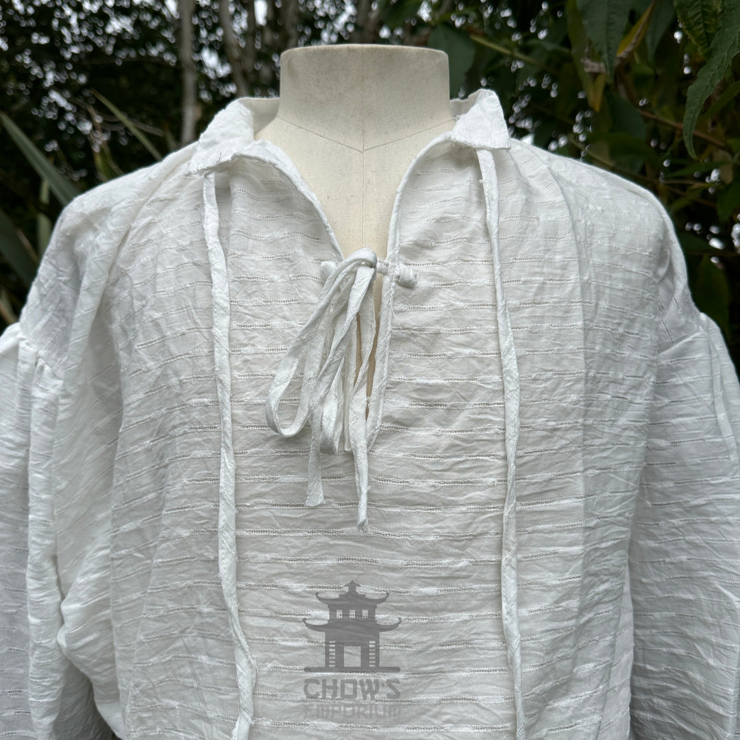 Close view of the lace-up neckline on the white medieval shirt
