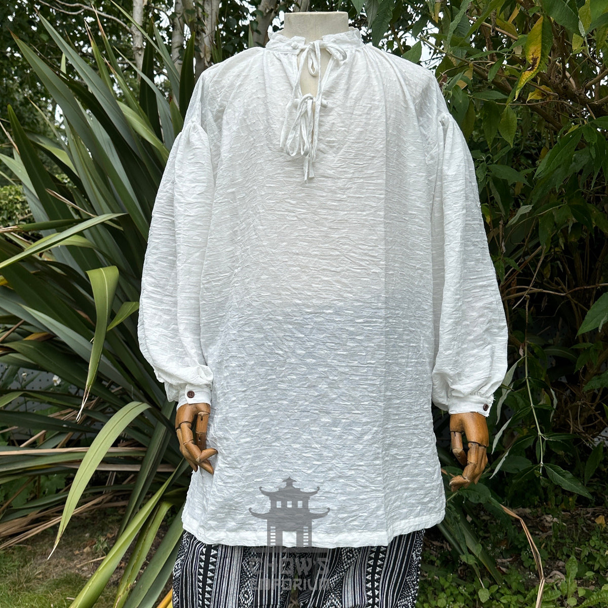 White textured cotton shirt with lace-up neckline and buttoned cuffs