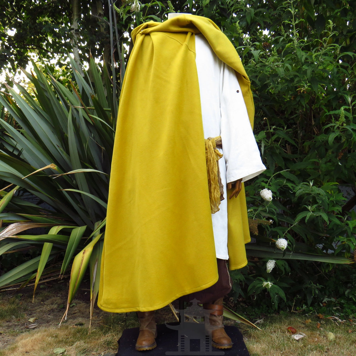 Mustard wool cloak folded back and draped over one shoulder as a cape