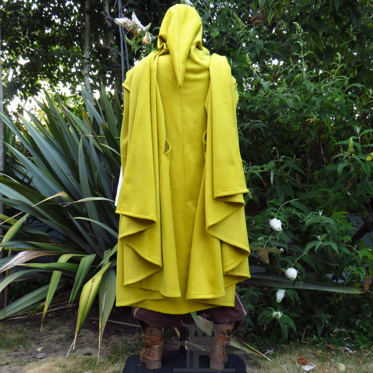 Back view of the mustard wool hooded cloak showing the long drape