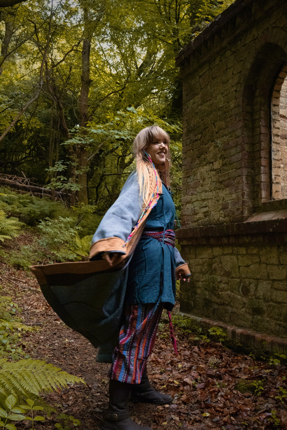 Side view of teal and brown two-tone pirate-style LARP coat, fantasy cosplay costume with.