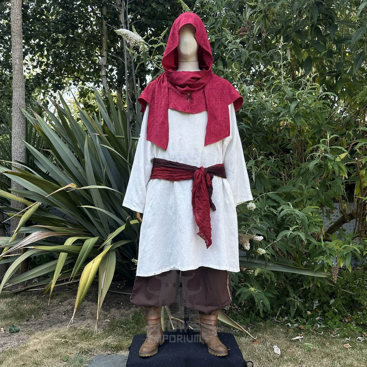 Red scarf hood worn as a cowl round the shoulders over a white shirt